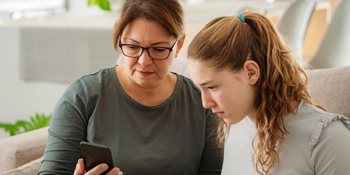 Mom and child looking at phone lab results 